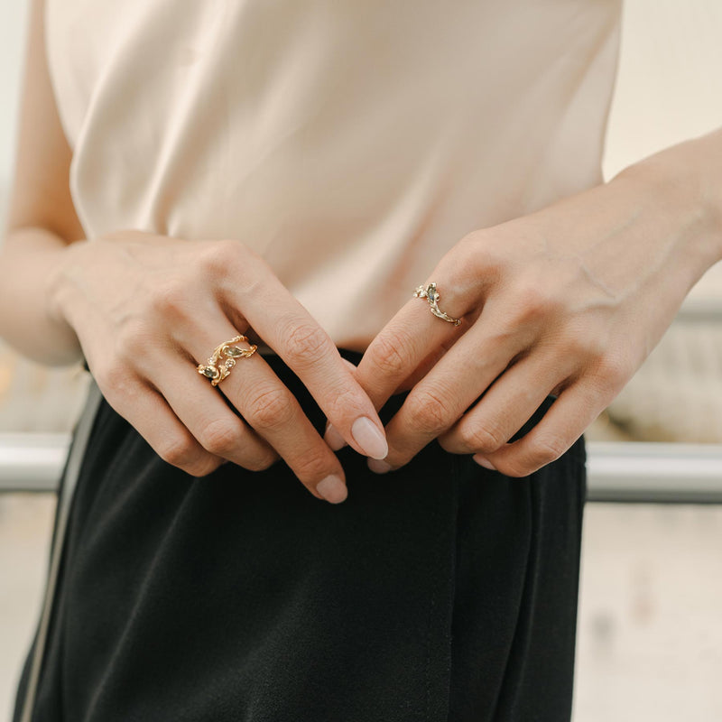 Yellow gold rococo baroque inspired scroll work ring featuring a rose cut labradorite and diamond. Handcrafted and finished. Shown on model with multiple stacks