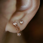 Rose gold stud earring featuring a 2.5mm rose cut diamond. Hand made and finished. Worn on earring.